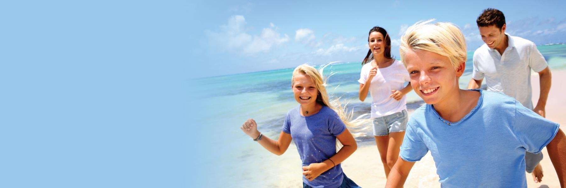 happy family jogging in the beach