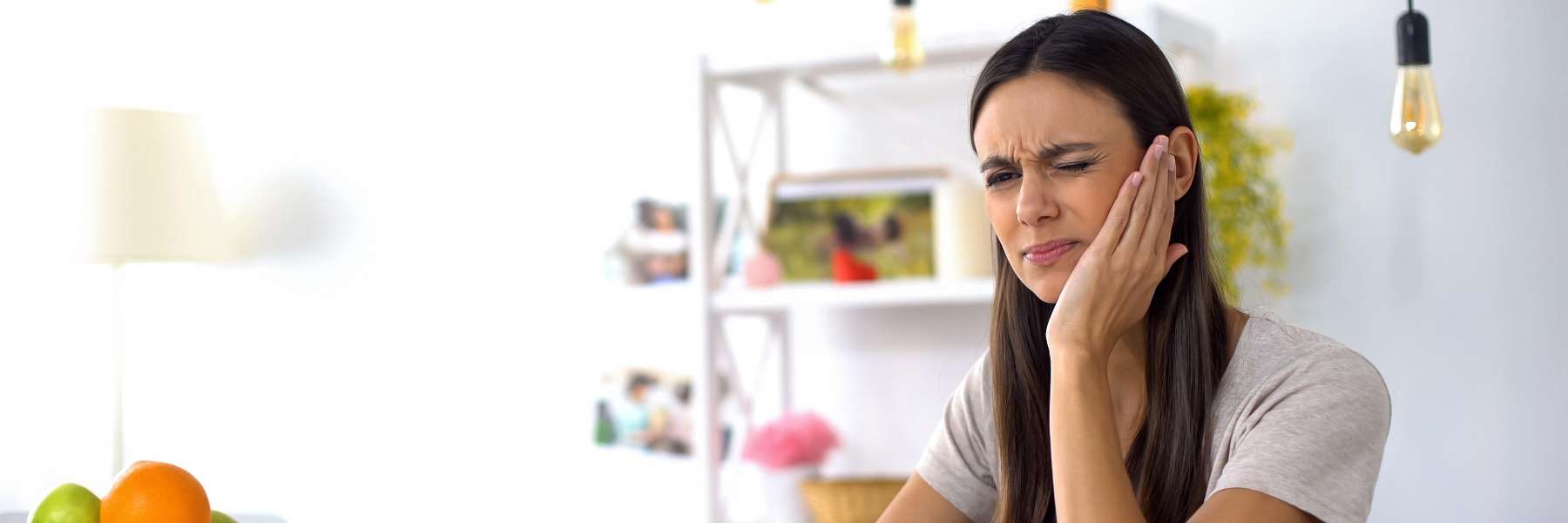 woman holding her left check